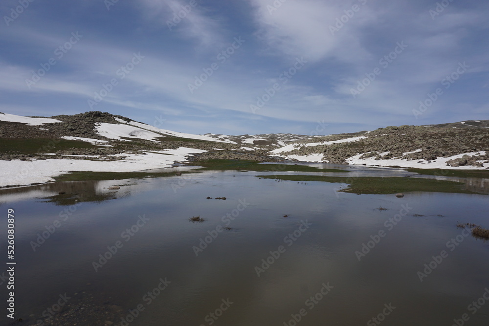 stony and snowy mountain, cloudy sky and lake, Dogubayazit, Agri, Turkey