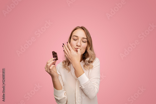 Young woman with chocolate licking finger