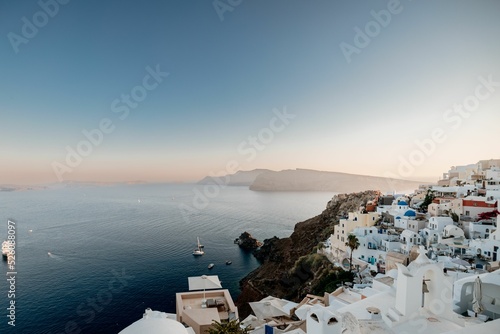 Beautiful view of white buildings at shore in Santorini, Greece photo