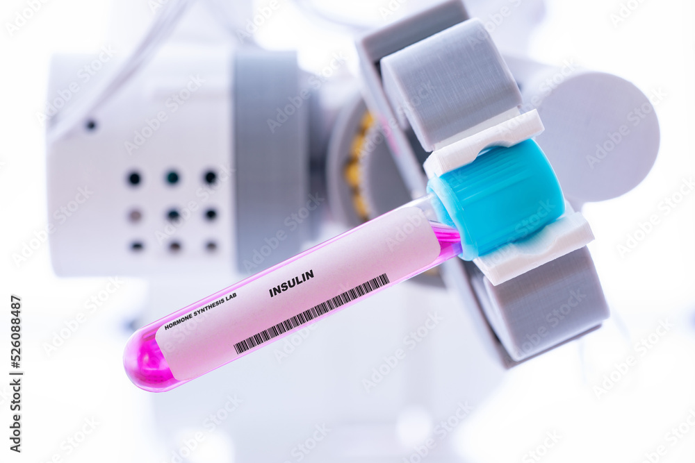 Insulin. Test tube with artificial hormone in robot hand Insulin Insulin. Test tube with artificial hormone in robot hand Insulin