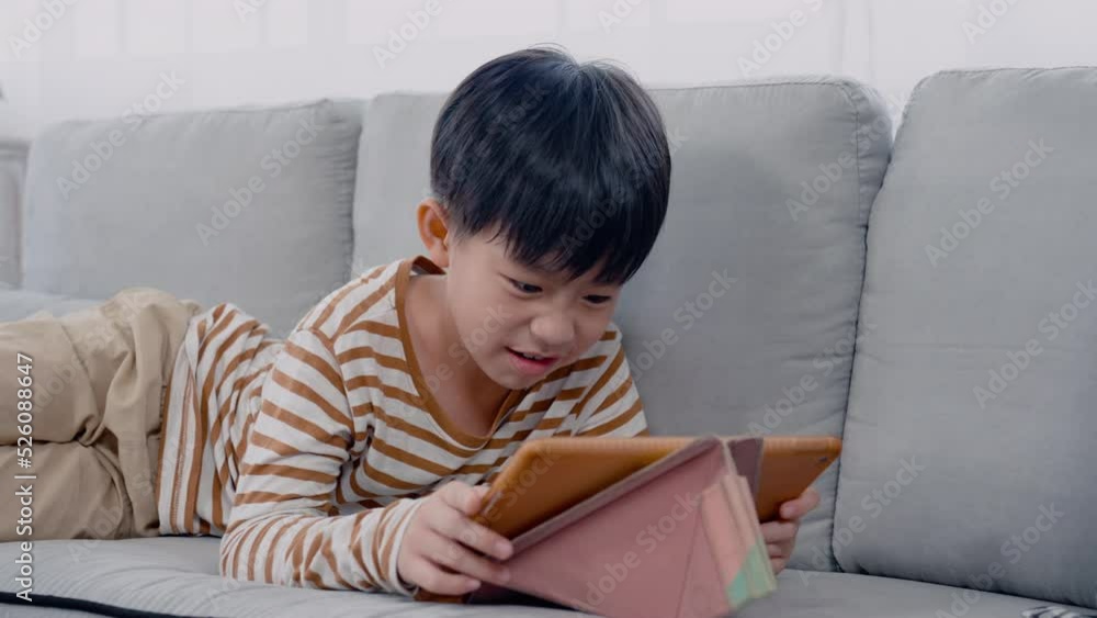 4K, slow motion, Handsome Asian boy, lying on sofa in his comfortable position, He played game frantically, and his demeanor was extremely fun, His expression looked happy, furious while playing game. 4K, slow motion, Handsome Asian boy, lying on sofa in his comfortable position, He played game frantically, and his demeanor was extremely fun, His expression looked happy, furious while playing game.