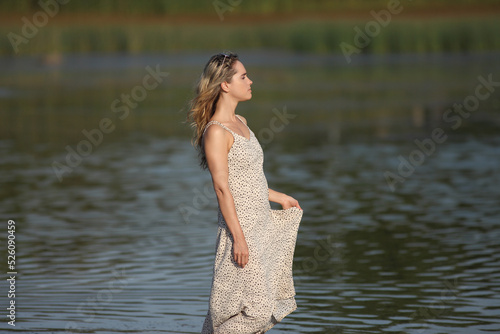 young woman in the water in a dress