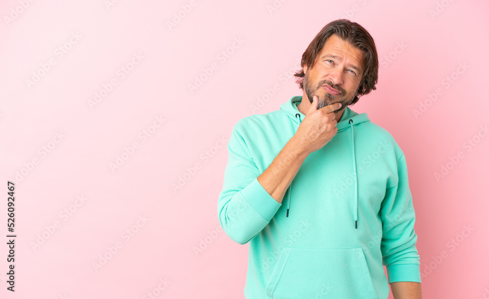 Senior dutch man isolated on pink background thinking Senior dutch man isolated on pink background thinking