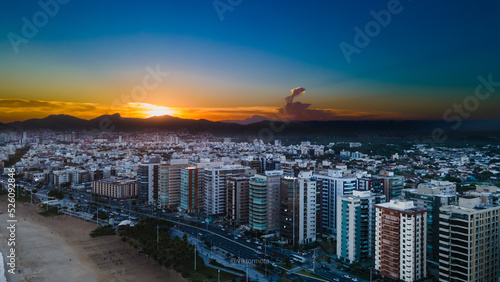 Sunset over the city - view from Camburi beach, frist plane Mata da Praia district © Viktor