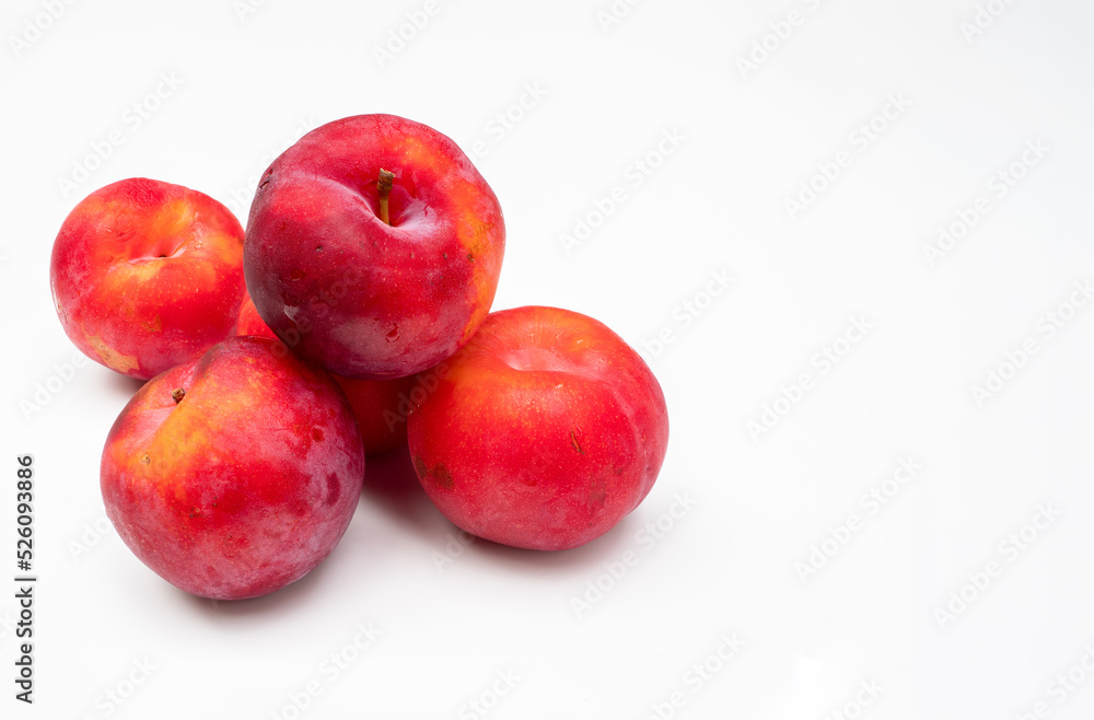 Freshly harvested sweet juicy plums on a white background Freshly harvested sweet juicy plums on a white background