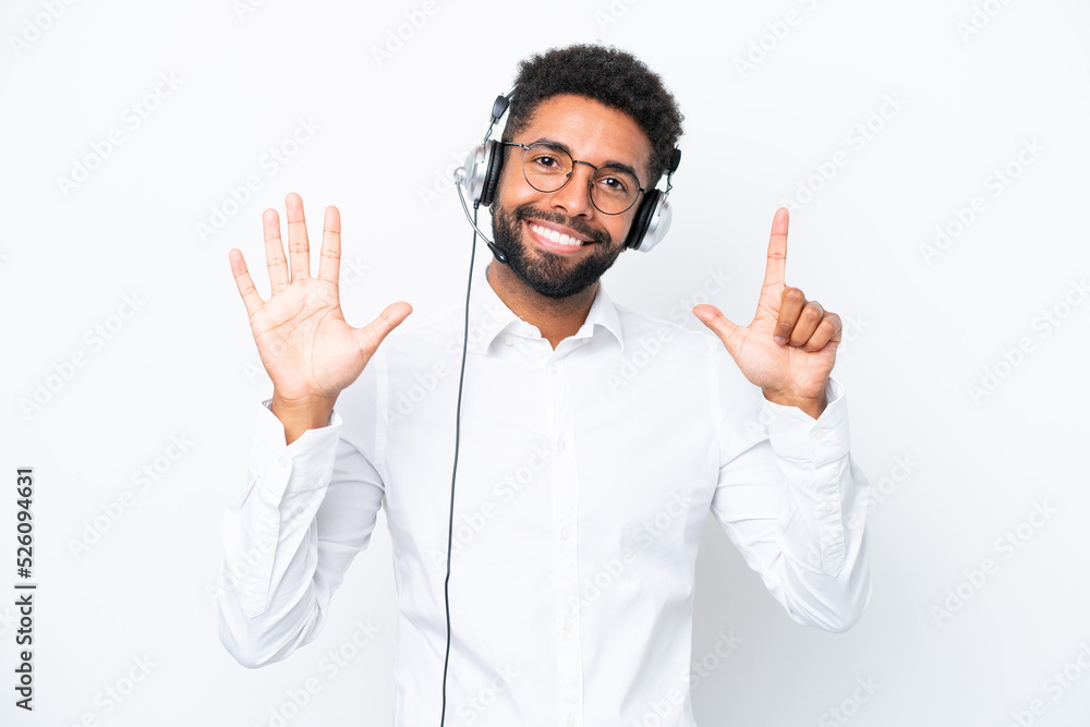 Naklejka premium Telemarketer Brazilian man working with a headset isolated on white background counting seven with fingers
