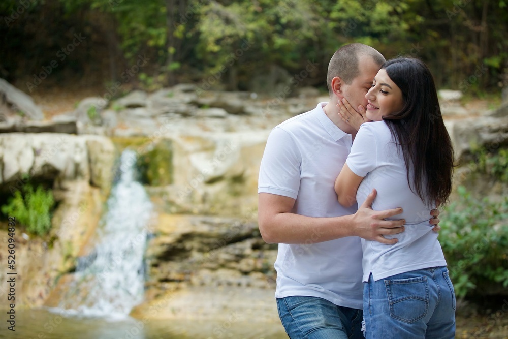 Lovers are in the woods by the waterfall. Lovers are in the woods by the waterfall.