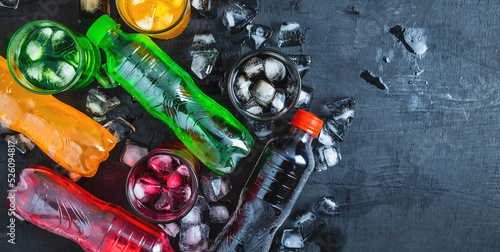 Quadro su tela Top view  lot of bottles Soft drinks in colorful and flavorful  on the table, Gl