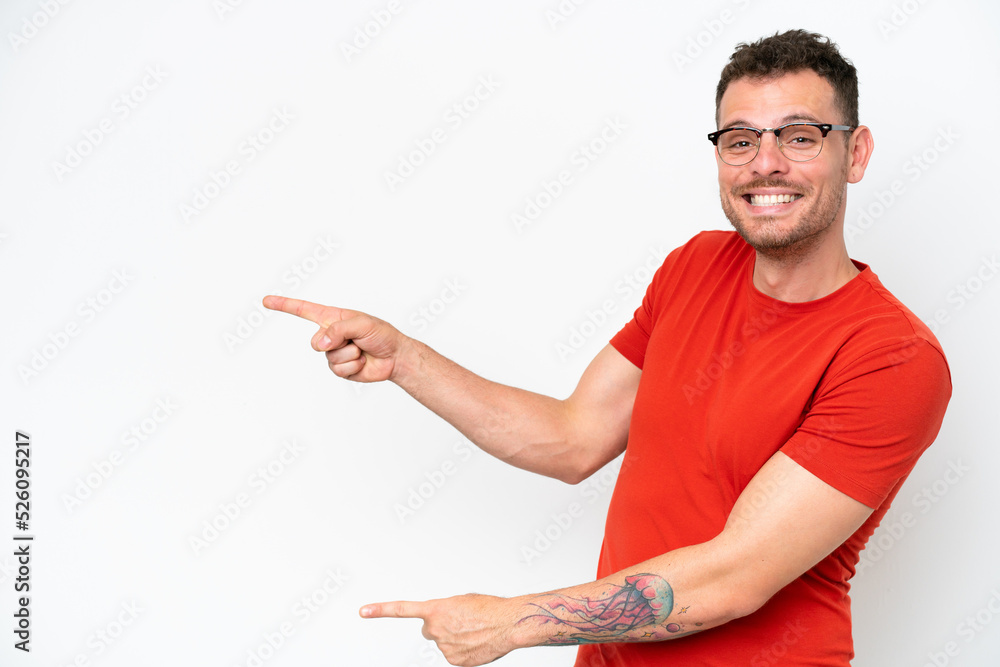 Young caucasian handsome man isolated on white background pointing finger to the side and presenting a product Young caucasian handsome man isolated on white background pointing finger to the side and presenting a product