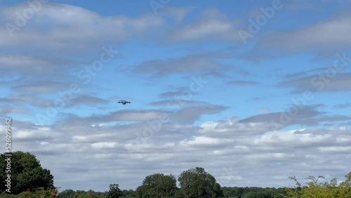 British army paratroopers (3 PARA) parachuting on an overhead assault , wearing body armour and webbing with weapons and daysacks suspended by rope below, blue sky photo