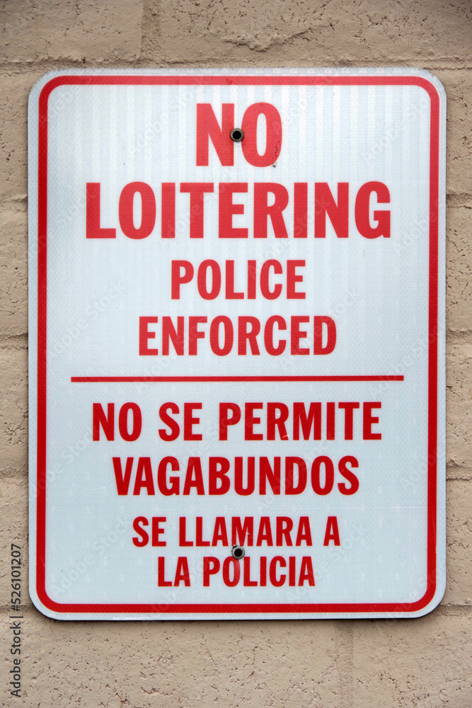 Naklejka premium NO LOITERING POLICE ENFORCED sign on a wall