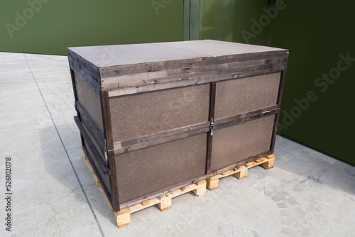 Big wooden box on two palle...
