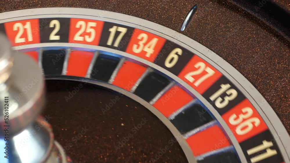 Ball on wooden french roulette table in casino. Wheel spinning, turning or rotating. Odd and even numbers, black, red and zero sectors. Bets in game of chance. Money playing, gambling or risky betting Ball on wooden french roulette table in casino. Wheel spinning, turning or rotating. Odd and even numbers, black, red and zero sectors. Bets in game of chance. Money playing, gambling or risky betting