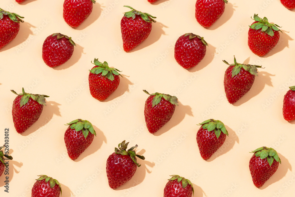 Fresh red strawberry isolated on peach background, top view. Minimalistic strawberry pattern. Flat lay, copy space Fresh red strawberry isolated on peach background, top view. Minimalistic strawberry pattern. Flat lay, copy space