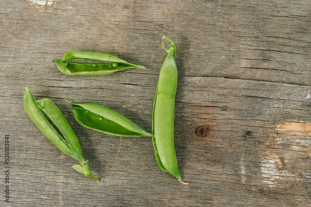 fresh green peas on a wooden background. Empty pea skins fresh green peas on a wooden background. Empty pea skins