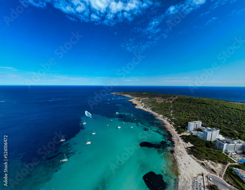 Drone view of the sea, beach and hotels in Mallorca with small boats
