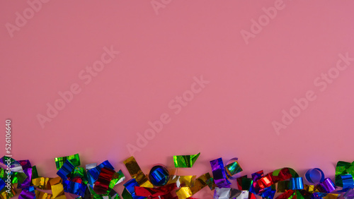 Christmas confetti on a pink background.