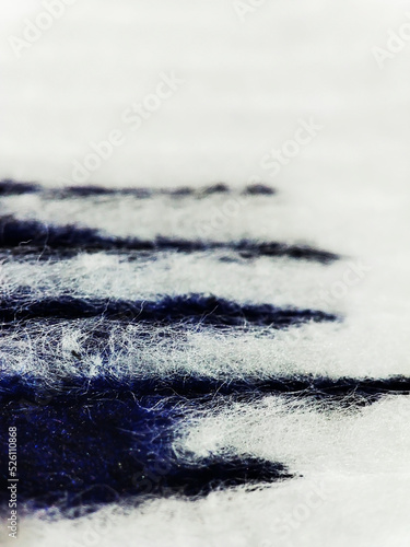 macro texture of blue paint on white fabric