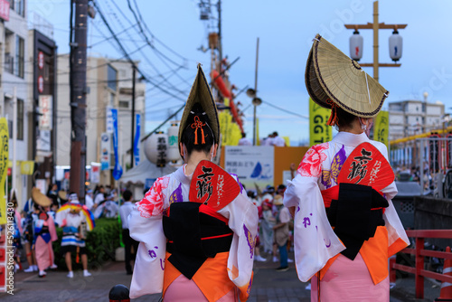 Two women in traditional hats and kimonos at Awaodori festival in Tokushima, Japan photo