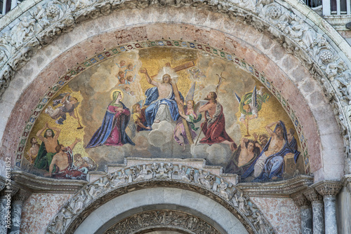 St Mark`s Basilica close-up, Venice, Italy. It is top landmark in Venice. Beautiful luxury mosaic portal, image of Christ and cross.