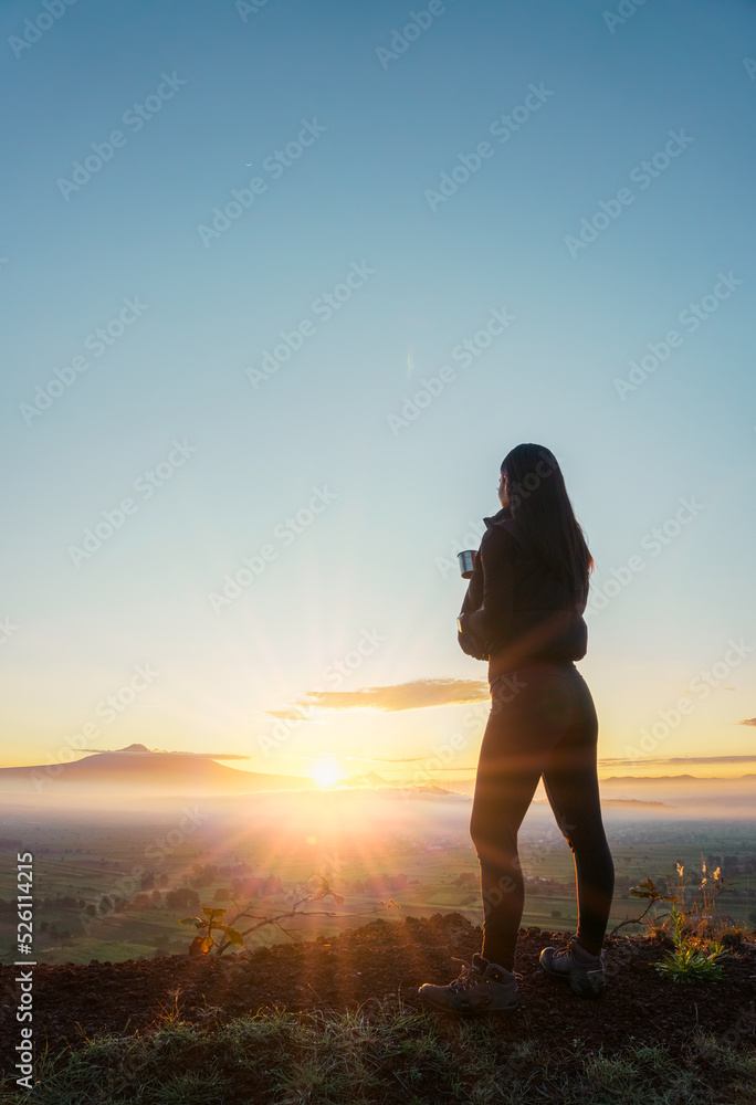 A young tourist woman drinks a hot drink from a cup A young tourist woman drinks a hot drink from a cup
