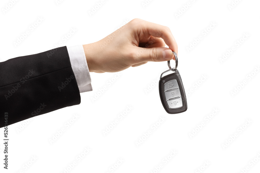 Male hand in a suit and white shirt holding car keys Male hand in a suit and white shirt holding car keys