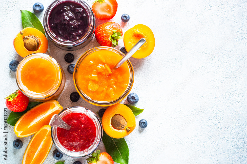 Jam set, natural preservation in glass jars with fresh fruits and berries. Top view on white table. Jam set, natural preservation in glass jars with fresh fruits and berries. Top view on white table.