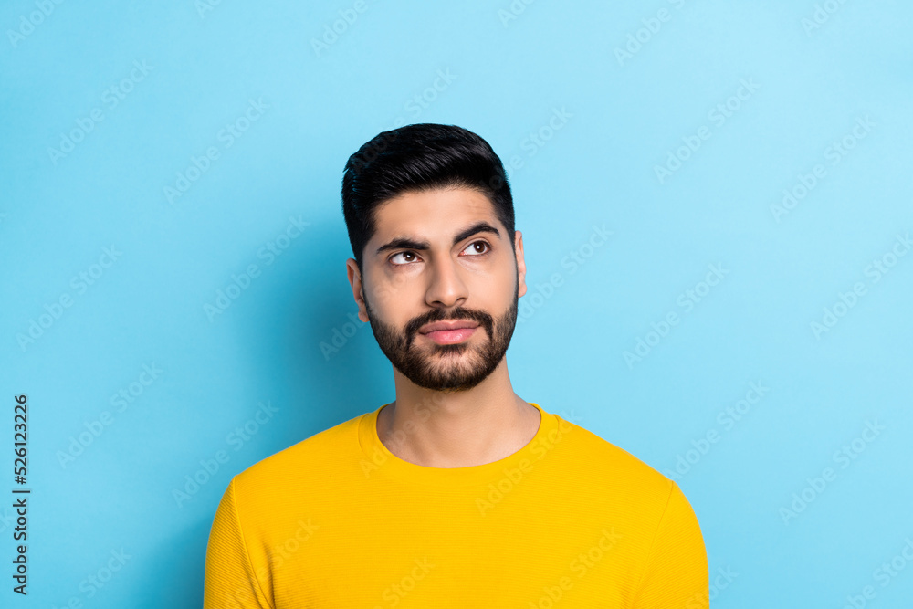 Fototapeta premium Photo of serious confident guy dressed yellow pullover looking empty space isolated blue color background