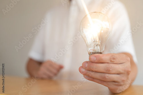 Man holding light bulbs, ideas of new ideas with innovative technology and creativity. concept creativity with bulbs that shine glitter, keys to success.Concept of new idea and innovation
