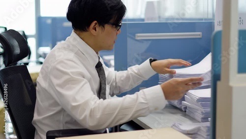Wallpaper Mural Overload office worker. Asian office worker is sitting at his desk clearing a lot of paperwork feel stressed and busy at the office. Torontodigital.ca
