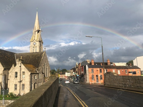 A beautiful rainbow over Saint Patrick Parish Church and houses, Ringsend, Dublin 4, Ireland. Best Dublin cityscape. Most popular Irish tourist destinations and main Ireland tourist attractions