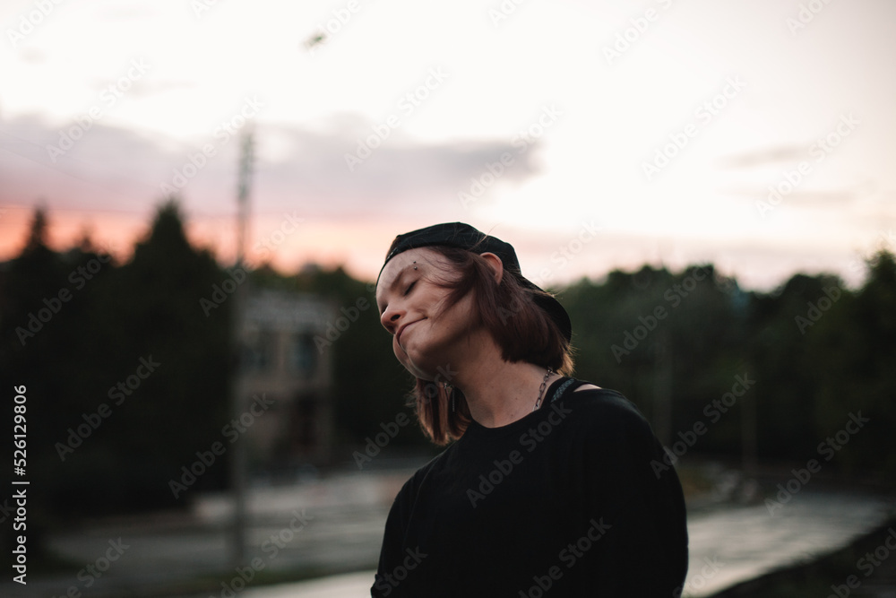 Happy young woman enjoying music walking on street after the rain Happy young woman enjoying music walking on street after the rain