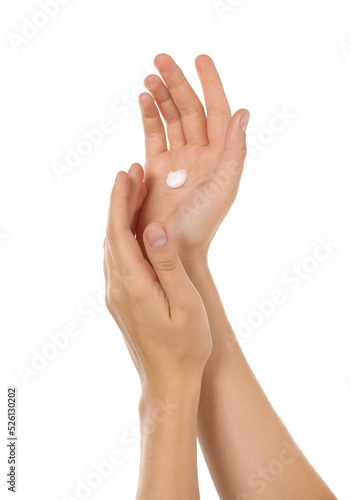 Woman applying cream on hand against white background  closeup