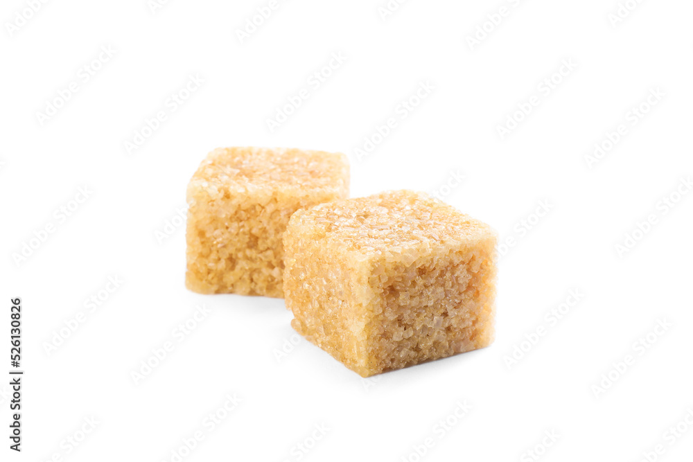 Two brown sugar cubes isolated on white Two brown sugar cubes isolated on white