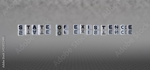 state of existence word or concept represented by black and white letter cubes on a grey horizon background stretching to infinity