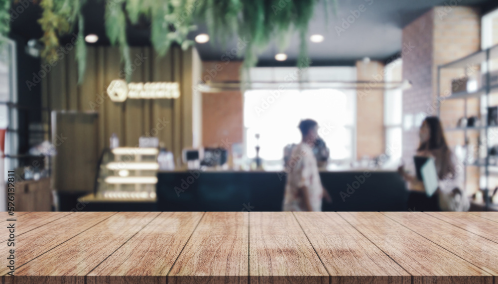 Empty wooden table top with lights bokeh on blur restaurant background. Empty wooden table top with lights bokeh on blur restaurant background.