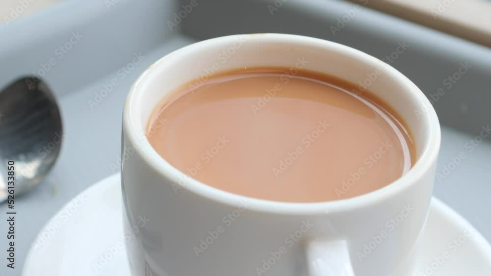 close up of cup of milk tea on table close up of cup of milk tea on table