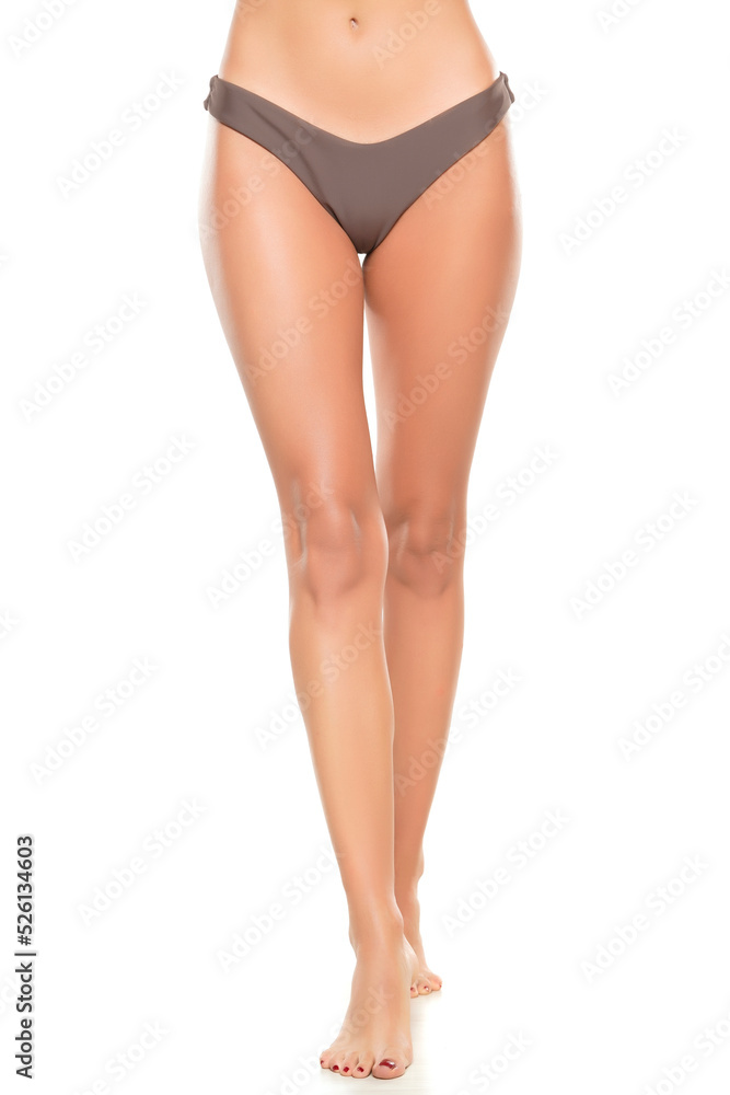 Female legs in black bikini panties ona white background Female legs in black bikini panties ona white background