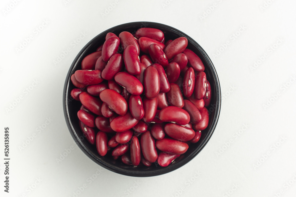 red kidney beans in a bowl on white background, top view, flat lay, top-down, selective focus. red kidney beans in a bowl on white background, top view, flat lay, top-down, selective focus.
