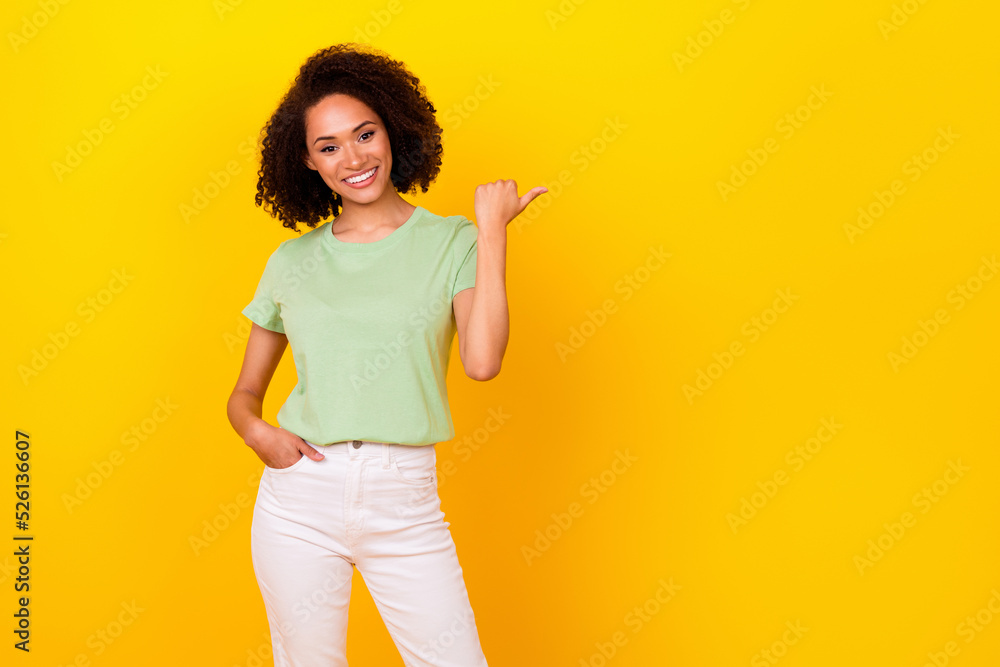 Photo of pretty brunette wavy lady index promo wear t-shirt pants isolated on bright yellow color background Photo of pretty brunette wavy lady index promo wear t-shirt pants isolated on bright yellow color background