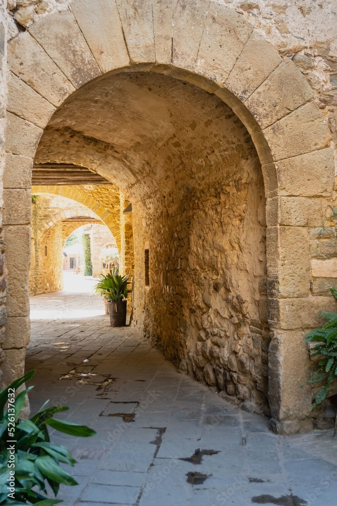 Monells, a beautiful medieval village in the Baix Empordà. Gerona. Spain. Arch in the narrow streets of the village