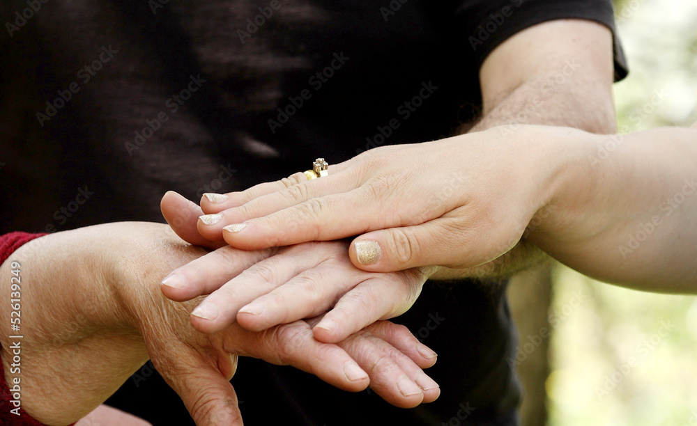 Hands of a grandma, son, daughter and child close-up, hand in hand. Next generation concept. Four generation together. 