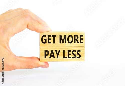 Get more pay less symbol. Concept words Get more pay less on wooden blocks on a beautiful white table white background. Businessman hand. Business Get more pay less concept. Copy space.