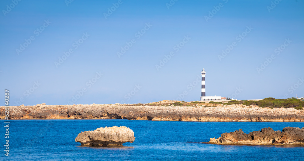 Scenic Artrutx Lighthouse at sunset in Minorca, Spain