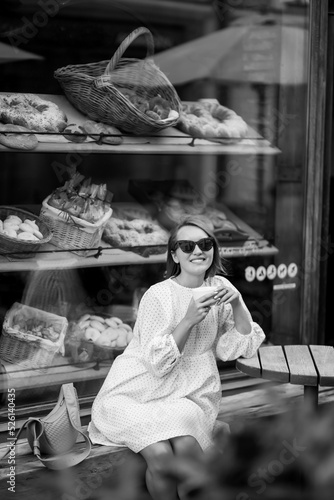 Happy woman in cafe on a city street. People, fashion, lifestyle, travel and vacations concept.