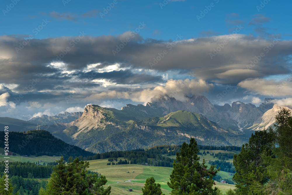 Moody sky over meadows and mountains in the Dolomites, Trentino Italy. Summer 2021 Moody sky over meadows and mountains in the Dolomites, Trentino Italy. Summer 2021