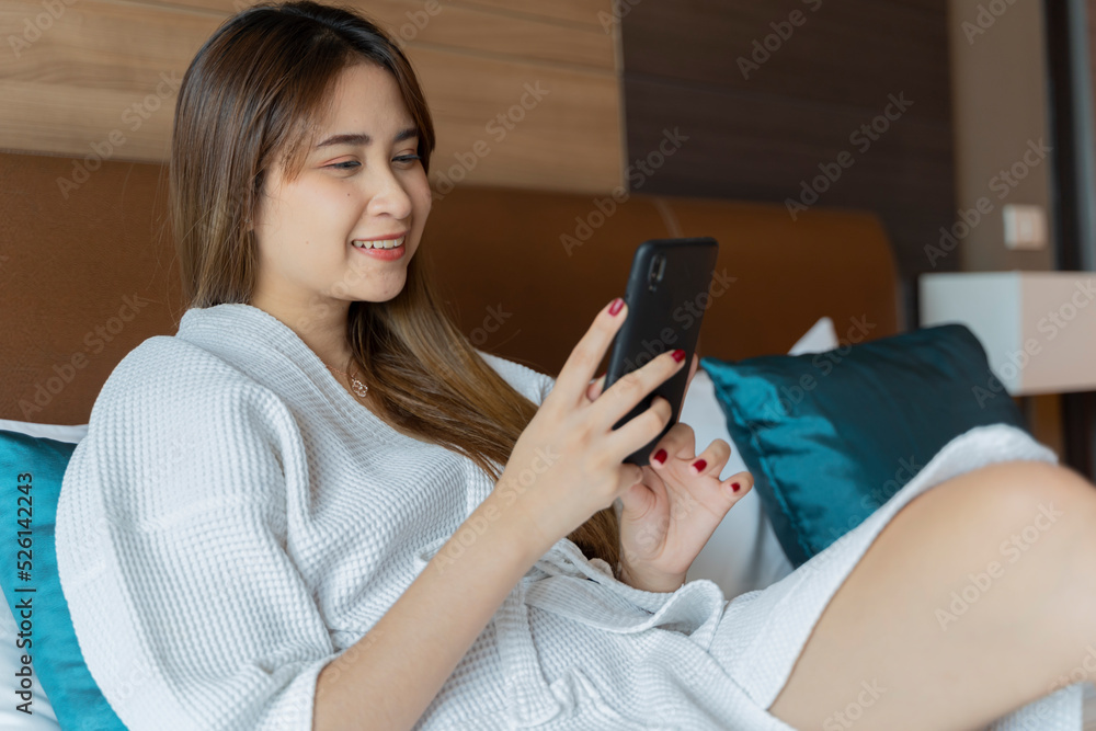 Beautiful calm and serene woman in palace hotel room lying on a king size bed Beautiful calm and serene woman in palace hotel room lying on a king size bed