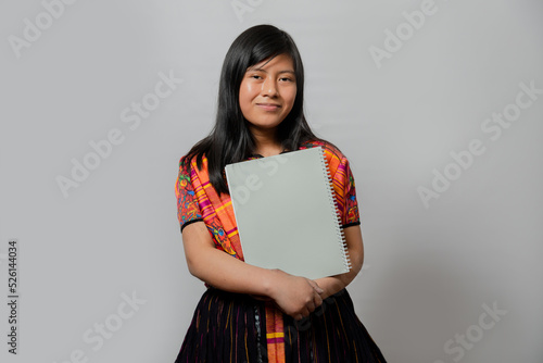 Hispanic young woman with notebook - Mayan teenager ready to go to study - Latina student on white background photo