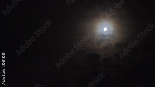 Real time video of beautiful night sky with full moon and clouds.