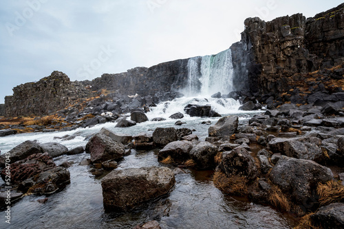 The beautiful Öxarárfoss waterfall flows from the river Öxará over black basalt rocks into the Almannagjá gorge, Þingvellir/Thingvellir National Park, Golden Circle Route, Iceland